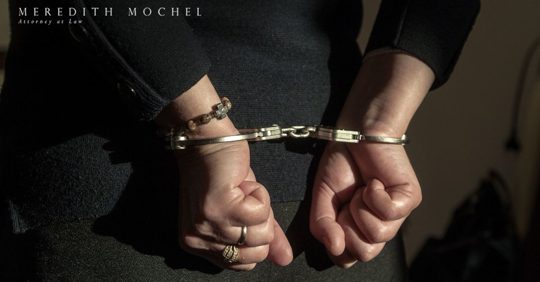 person in handcuffs