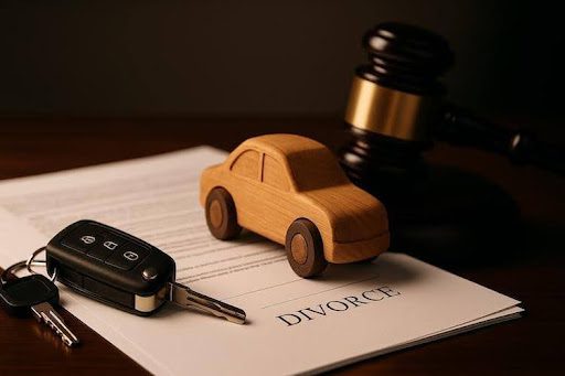 financed-car-division-tennessee-divorce car keys and wooden car on divorce papers symbolizing vehicle and debt division in a Tennessee divorce.